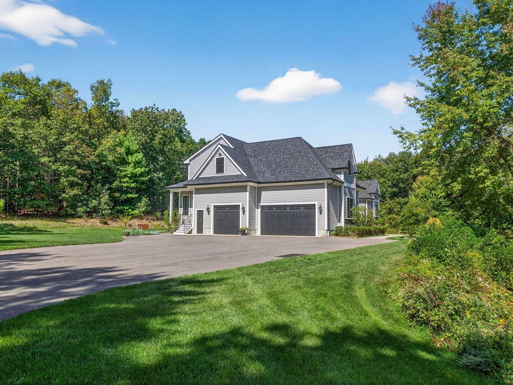 18 Keeney Pond Road Norfolk, MA 02056 - Photo 35 of 42 a front view of a house with a garden and yard