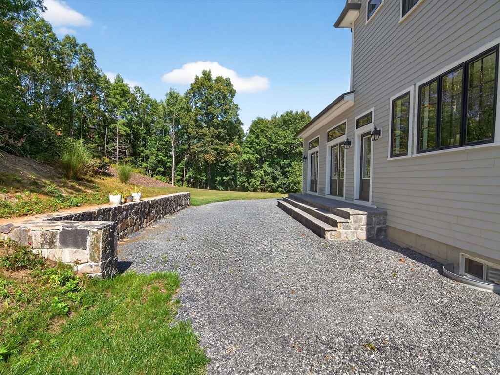 18 Keeney Pond Road Norfolk, MA 02056 - Photo 37 of 42 a house with trees in front of it