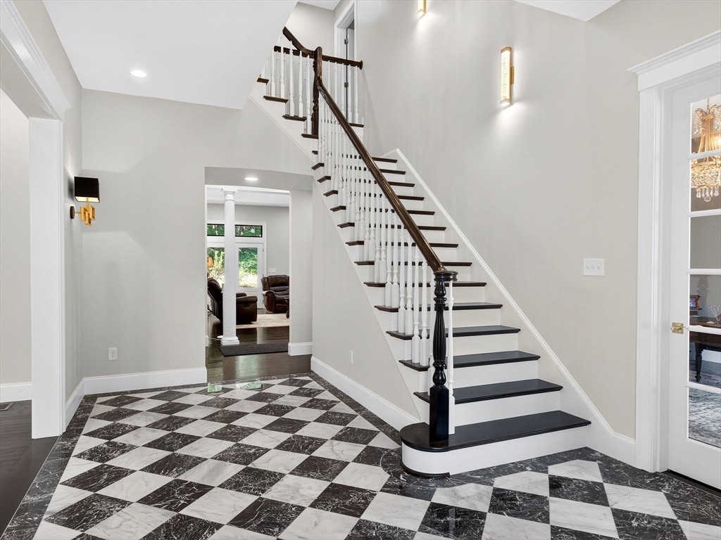 18 Keeney Pond Road Norfolk, MA 02056 - Photo 4 of 42 a view of a livingroom with wooden floor and white walls