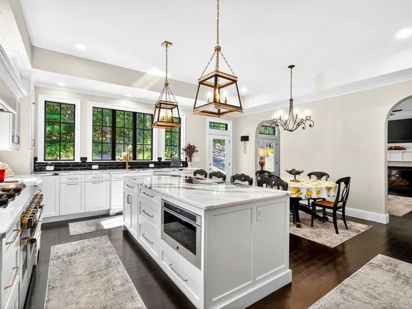 a kitchen with a stove and a view of living room