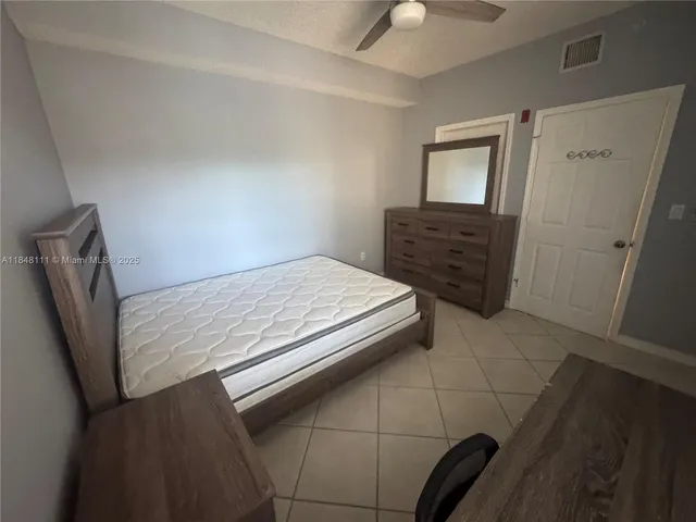 a view of a kitchen cabinets and refrigerator
