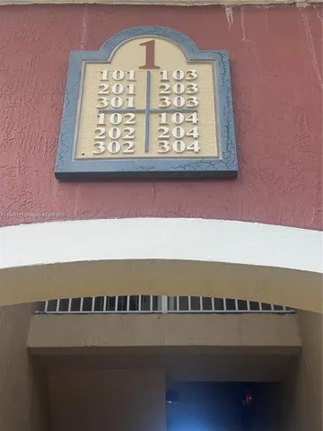 a view of a patio with table and chairs potted plants with wooden floor and fence