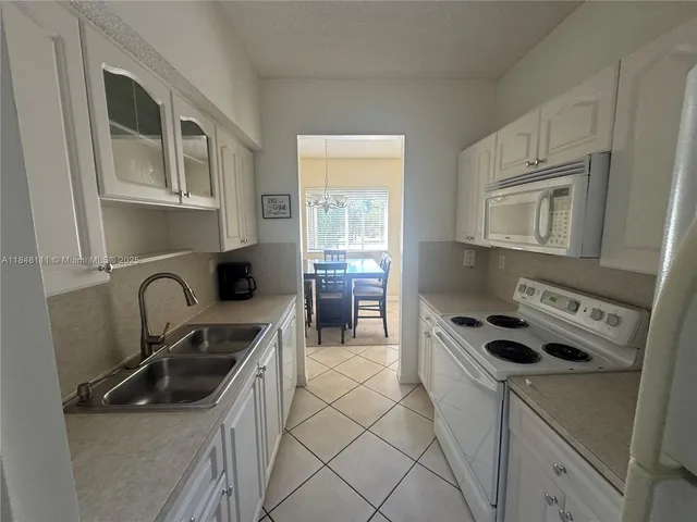 a kitchen with cabinets a sink and appliances
