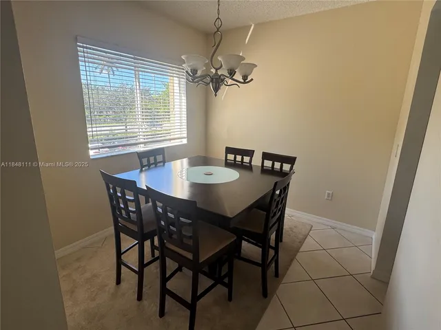 a view of a dining room with furniture and window