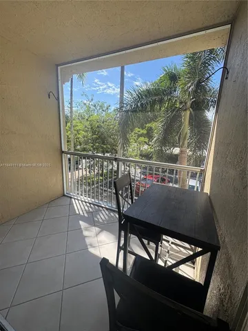 a view of a chairs and table in the balcony