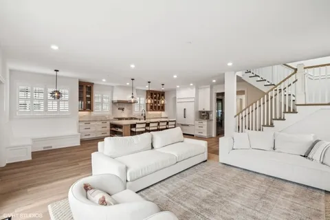 a living room with furniture white walls and wooden floor
