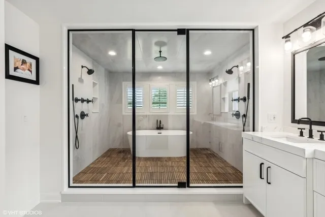 a bathroom with a granite countertop sink mirror and shower