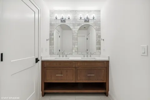 a bathroom with a double vanity sink and a mirror