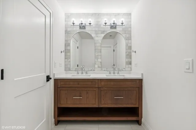 a bathroom with a double vanity sink and a mirror