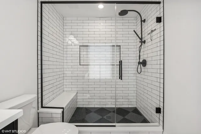 a bathroom with a toilet and a shower