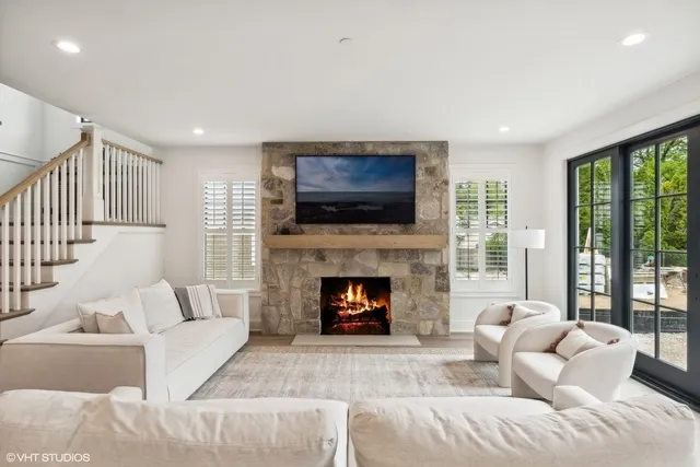 a living room with furniture a fireplace and a flat screen tv