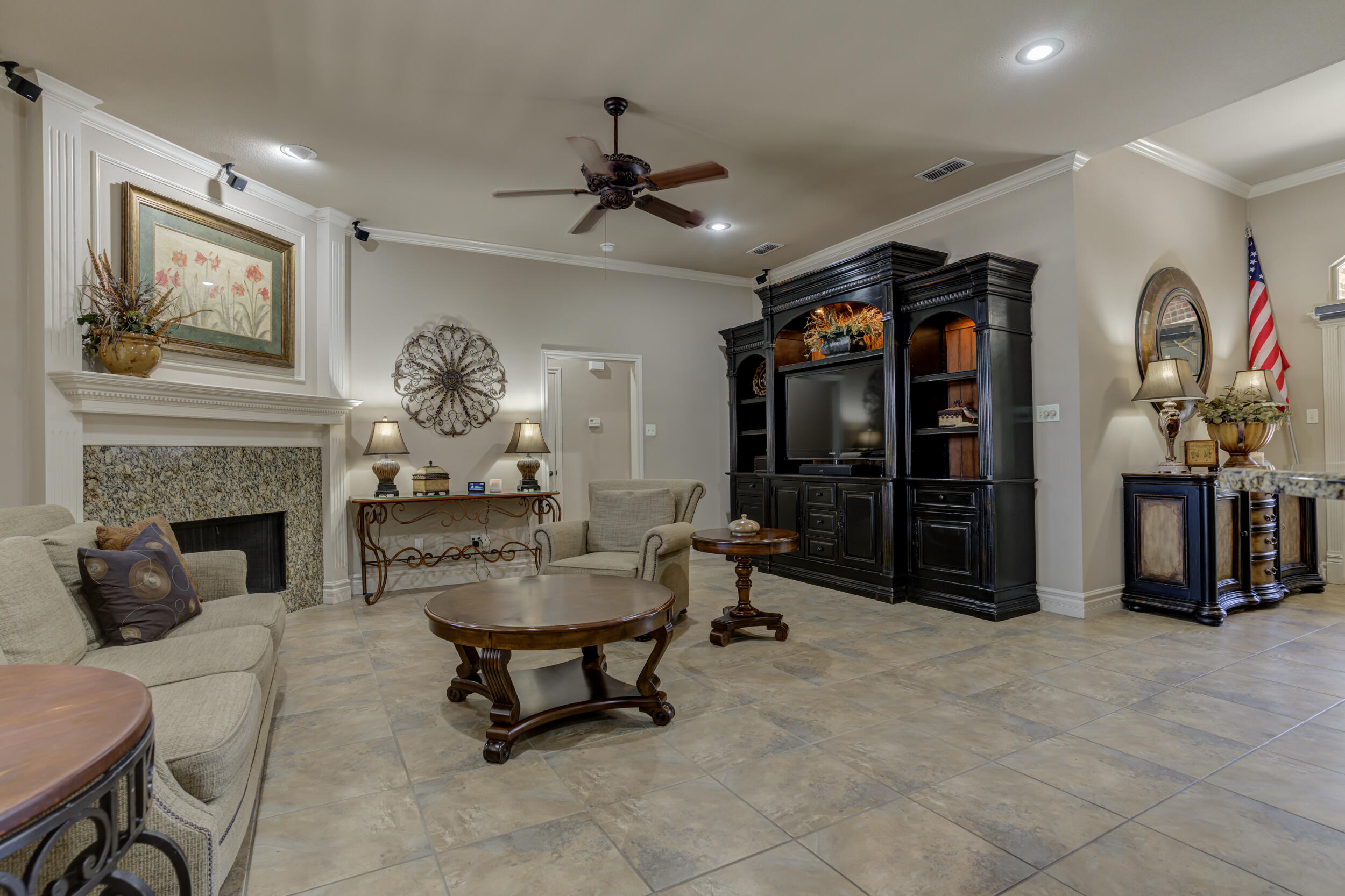 6008 89th Street Lubbock, TX 79424 - Photo 10 of 61 a living room with furniture a chandelier and a fireplace