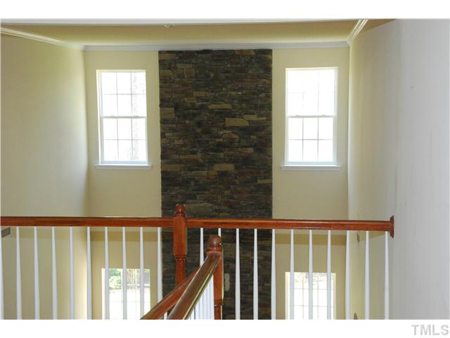 505 Thistlegate Trail Raleigh, NC 27610 - Photo 16 of 21 View of the hallway. Showing off the stone detail above the fireplace.