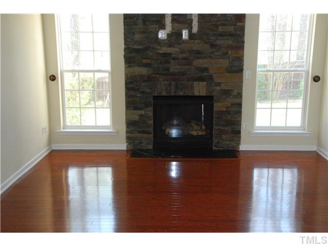 505 Thistlegate Trail Raleigh, NC 27610 - Photo 10 of 21 Beautiful Hardwoods and plenty of space. Oversized double hung windows, and Enjoy the view outside while sitting around the fireplace. Beautiful stone around the fireplace that goes all the way to the ceiling