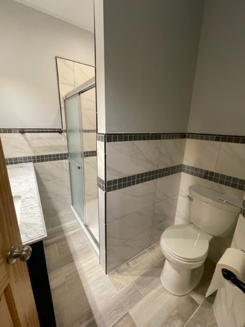 Undisclosed Address Chicago, IL 60644 - Photo 5 of 7 a bathroom with a toilet and a shower