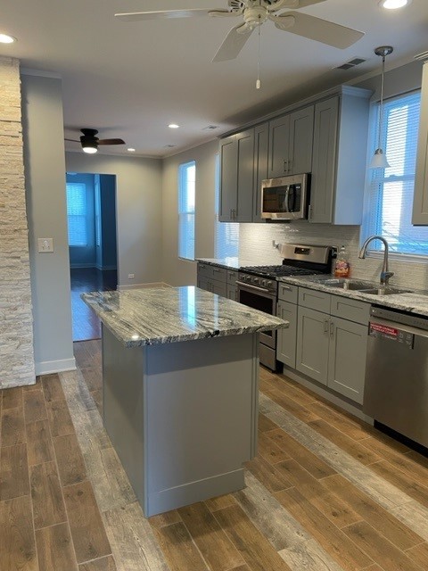 Undisclosed Address Chicago, IL 60644 - Photo 7 of 7 a large kitchen with stainless steel appliances granite countertop a stove a sink and a microwave