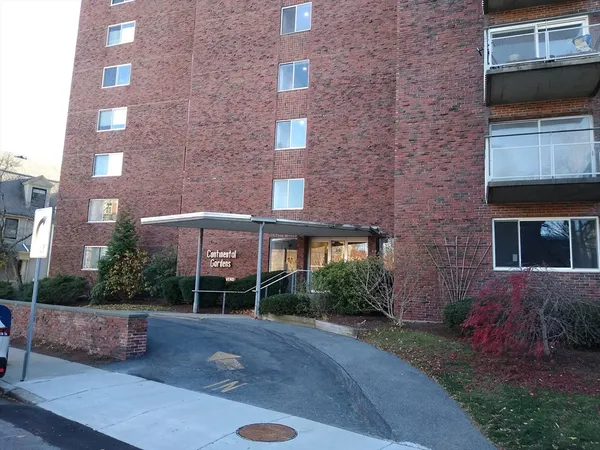 a front view of a building with a garden