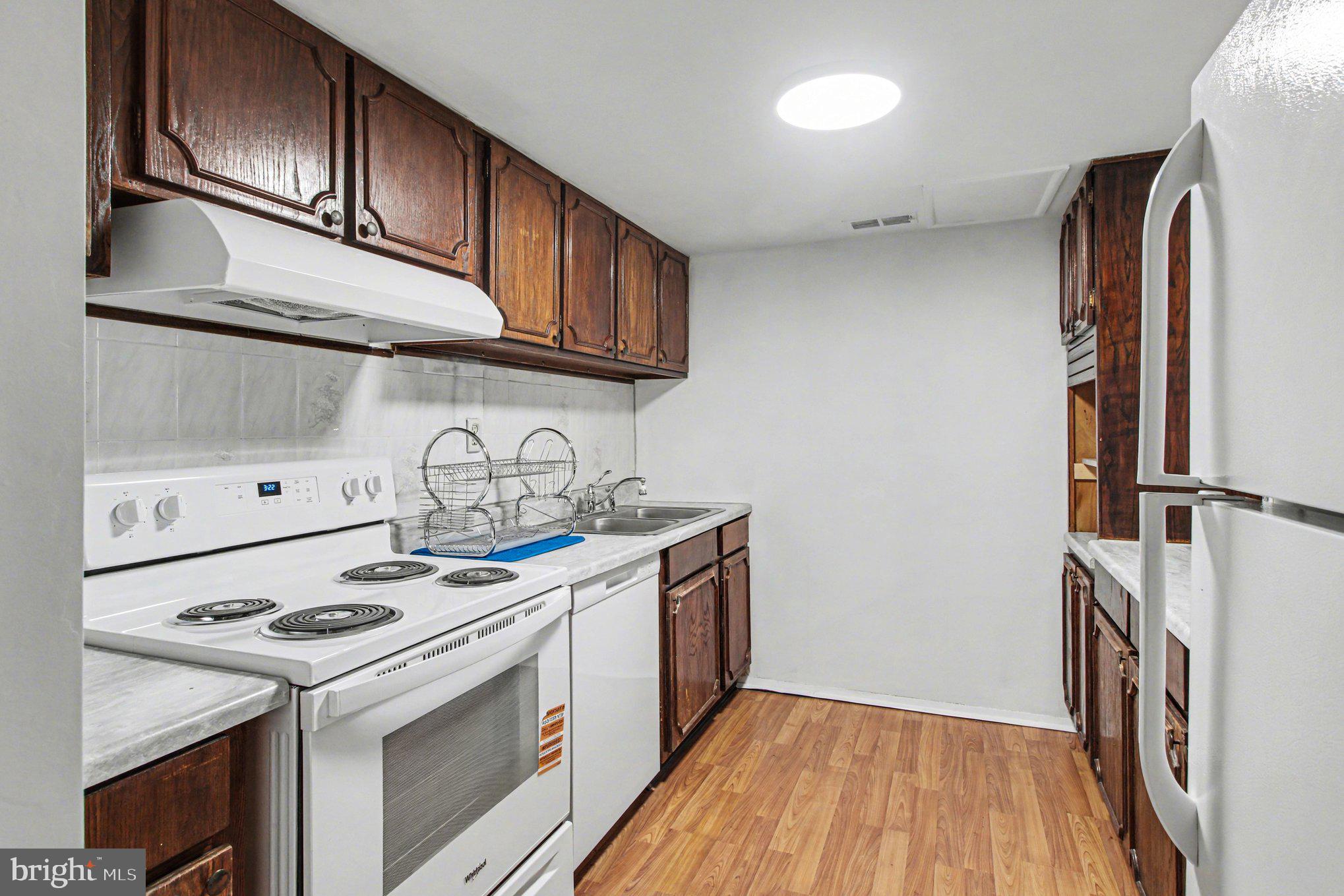 70 Rittenhouse Drive Willingboro, NJ 08046 - Photo 12 of 25 a kitchen with stainless steel appliances granite countertop a stove and a refrigerator