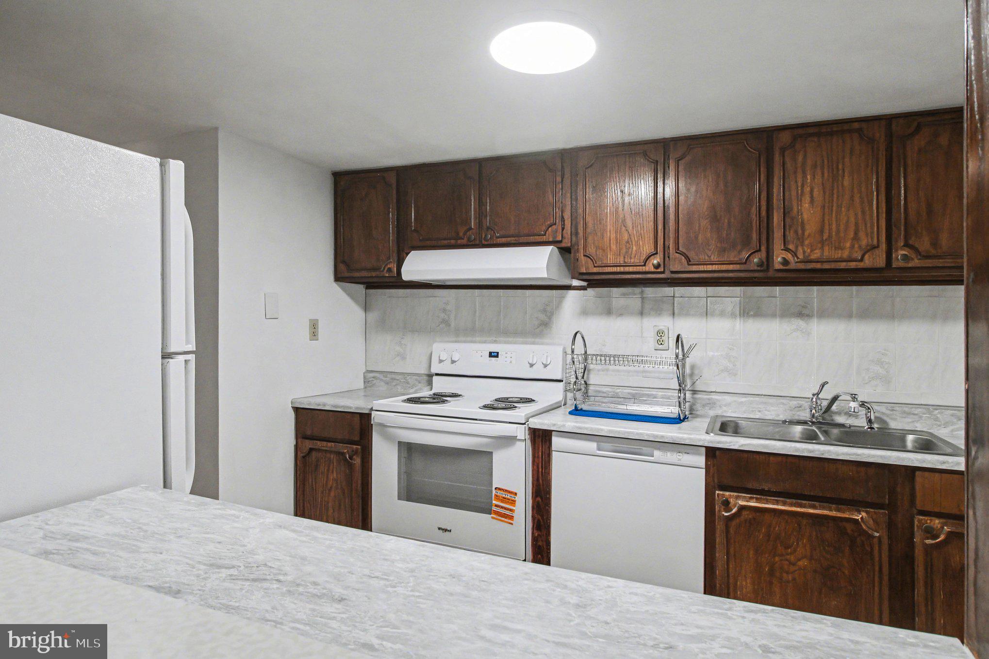 70 Rittenhouse Drive Willingboro, NJ 08046 - Photo 13 of 25 a kitchen with a stove sink and cabinets