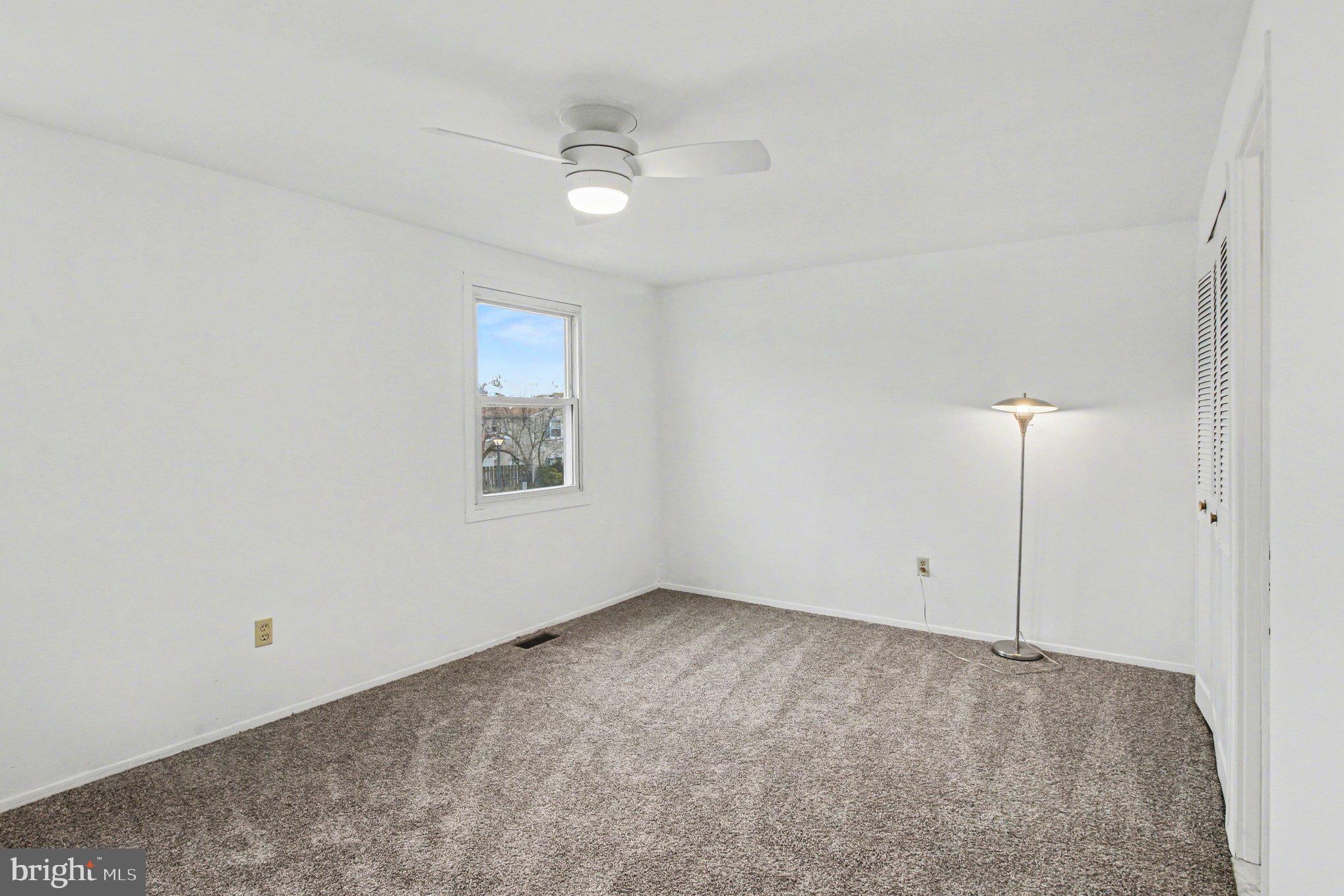 70 Rittenhouse Drive Willingboro, NJ 08046 - Photo 15 of 25 an empty room with a ceiling fan and a window