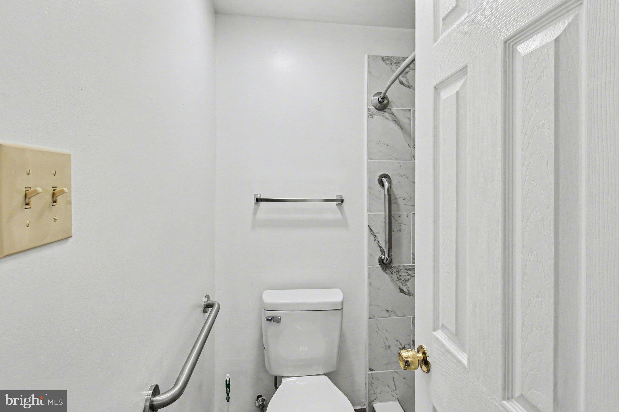 70 Rittenhouse Drive Willingboro, NJ 08046 - Photo 19 of 25 a white toilet sitting next to a shower curtain