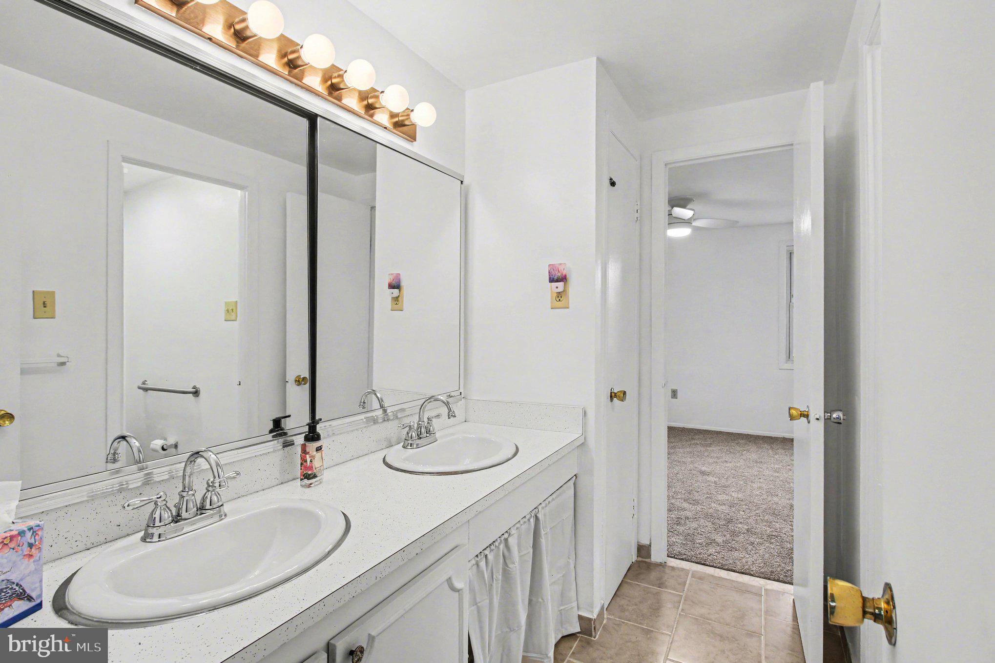 70 Rittenhouse Drive Willingboro, NJ 08046 - Photo 20 of 25 a bathroom with a sink double vanity and a mirror