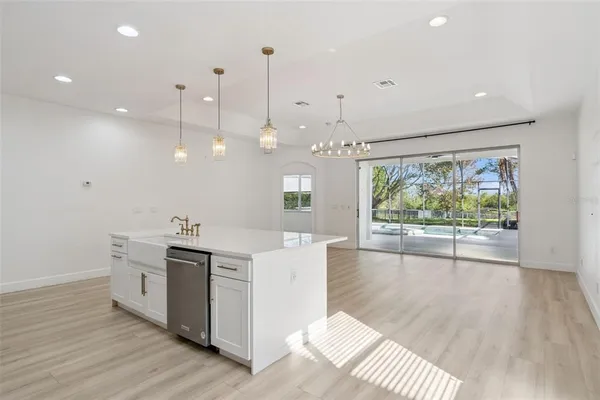 an empty room with ceiling fan and window