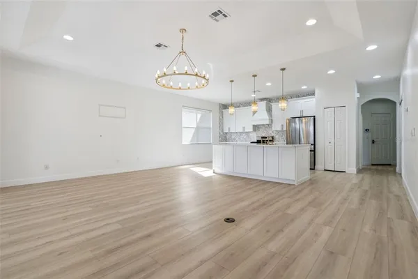 a spacious bedroom with a bed and a chair