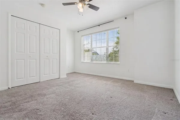a bathroom with a toilet mirror and vanity