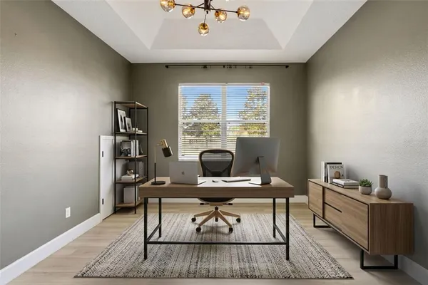 a view of a field of grass and trees