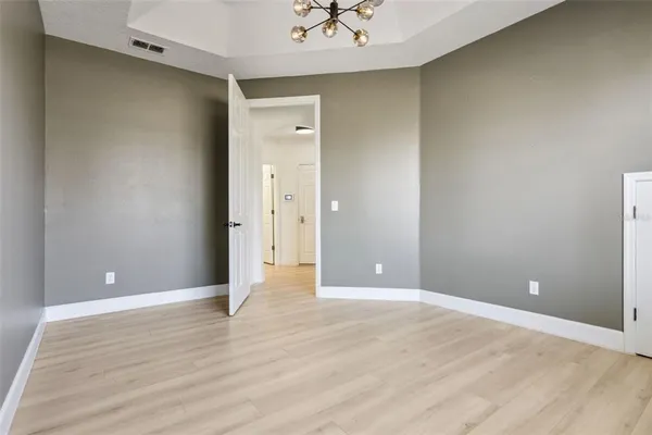 a view of a house with a big yard plants and large trees