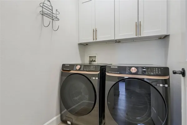 an aerial view of a residential houses with outdoor space and lake view