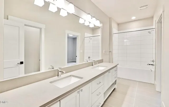 a bathroom with a sink double vanity granite tub and shower