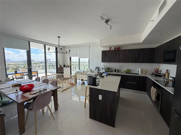 a kitchen with a table chairs refrigerator and cabinets