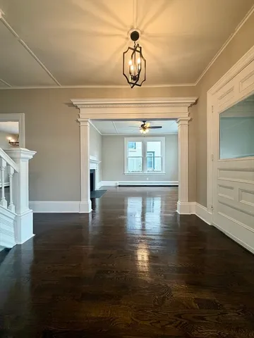 a view of a livingroom with wooden floor and a window