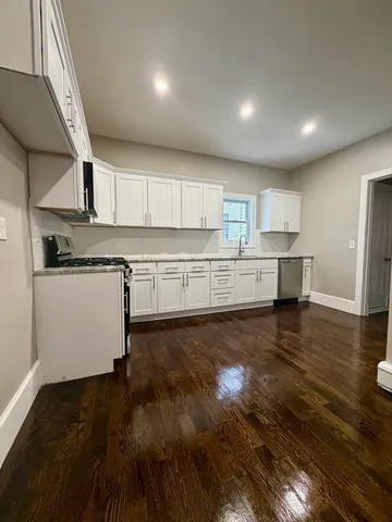 a kitchen with stainless steel appliances granite countertop a stove and a refrigerator