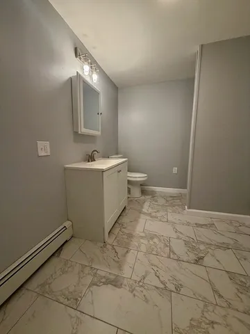 a bathroom with a sink a toilet and mirror
