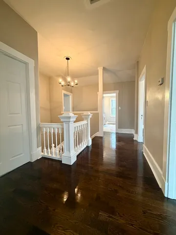 a view of a room with wooden floor windows and a livingroom