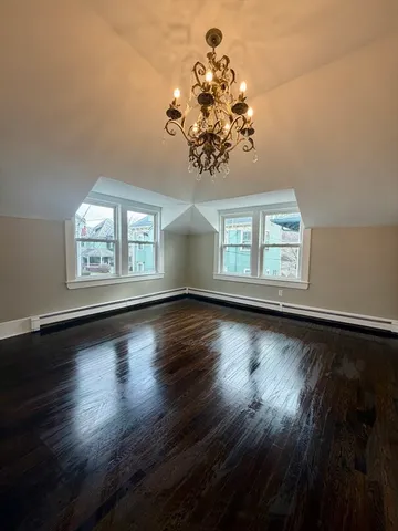 a view of a room with wooden floor and large windows