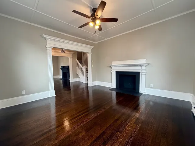 wooden floor in an empty room with a fireplace