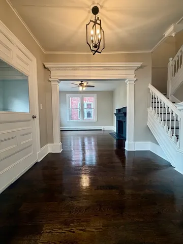 a view of an entryway with wooden floor