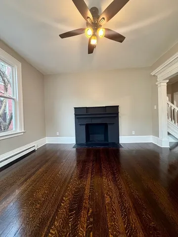 wooden floor in an empty room with a window
