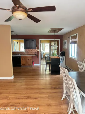 a view of a dining room with furniture window and wooden floor