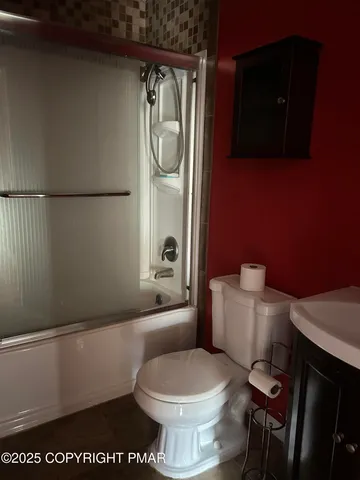 a bathroom with a toilet and a shower