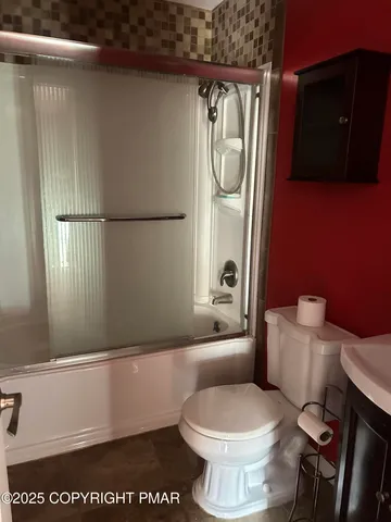 a white toilet sitting next to a bathroom sink