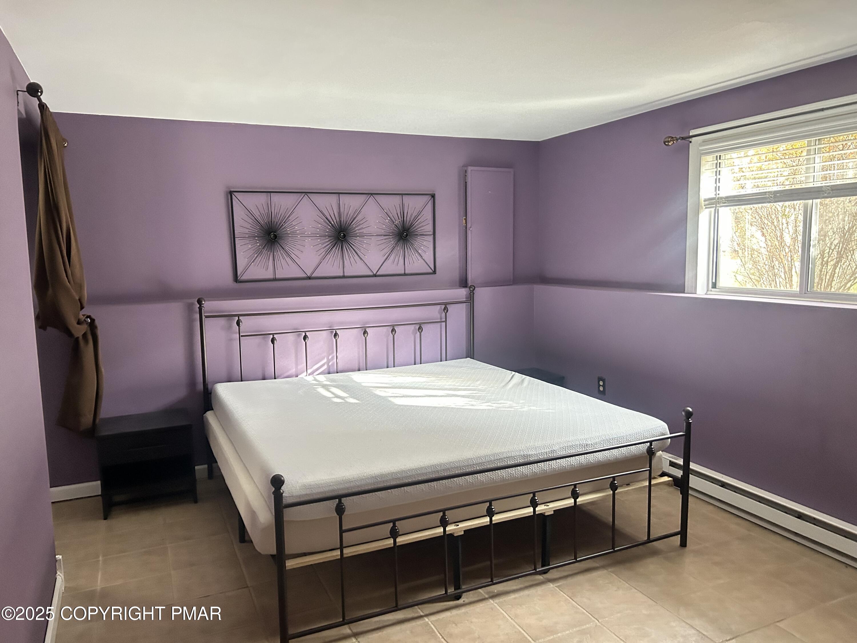 1152 Steele Circle Bushkill, PA 18324 - Photo 24 of 39 a bed sitting in a bedroom next to a window