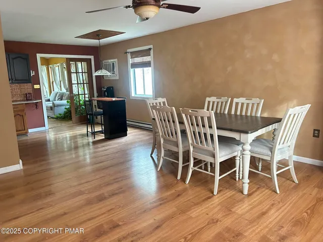 a view of a dining room with furniture window and wooden floor