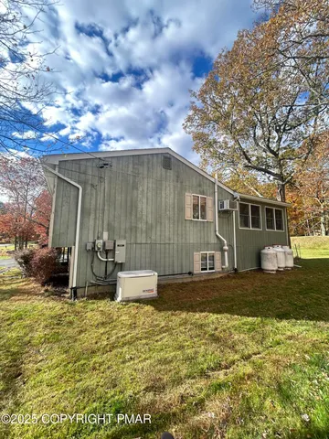 a view of a house with backyard and sitting area