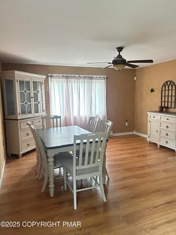 a dining room with furniture and window