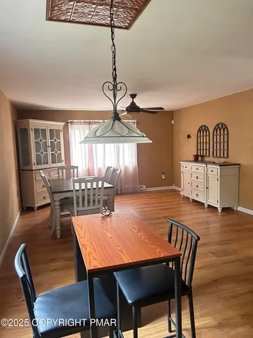 a dining room with furniture window and wooden floor